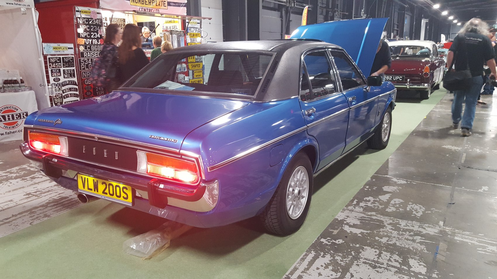 Vintage 1970s sedan with vinyl roof and illuminated rear brake lights