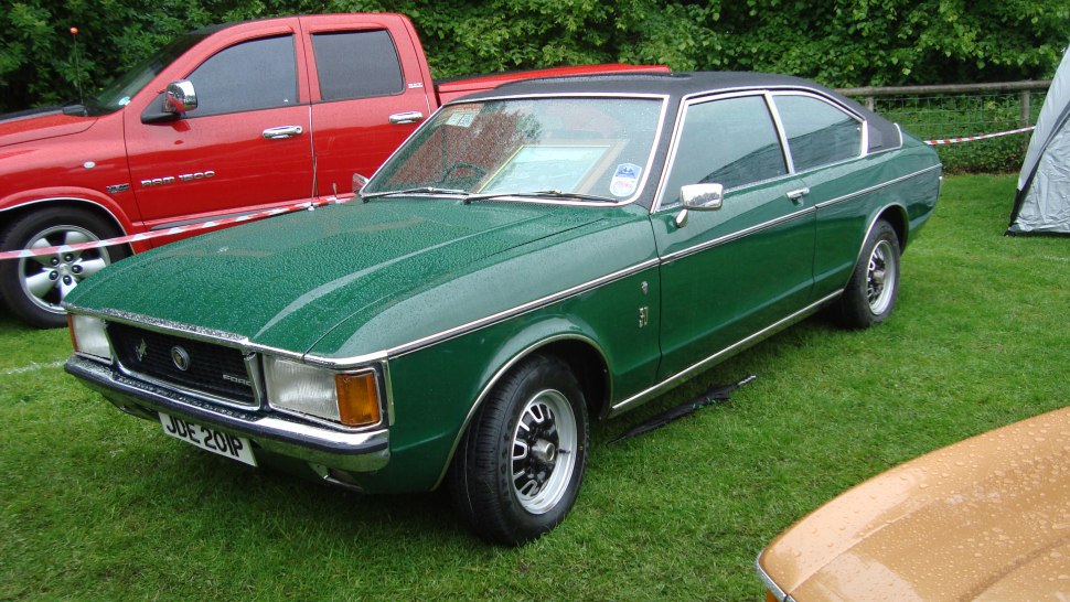 Vintage green coupe with vinyl roof and chrome details