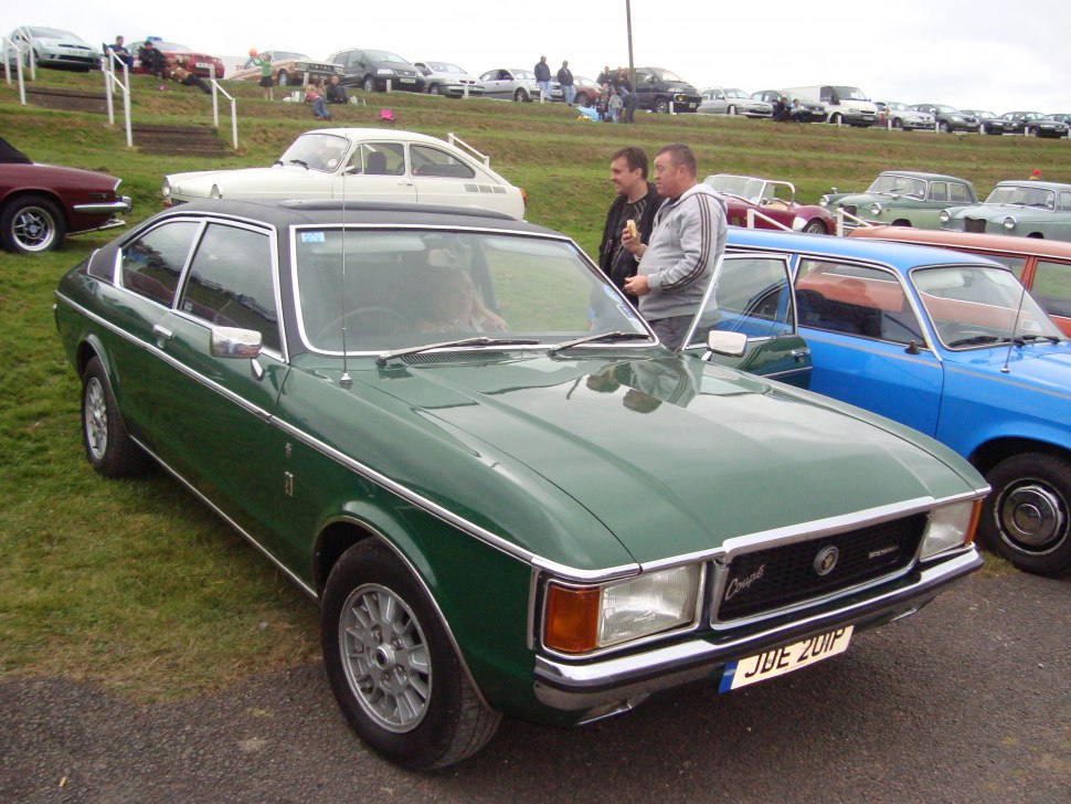 Vintage green 1970s coupe with chrome trim and alloy wheels