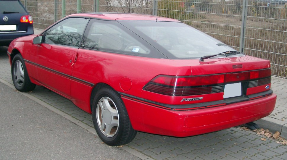 Sleek rear with horizontal tail lights and three-door coupe design