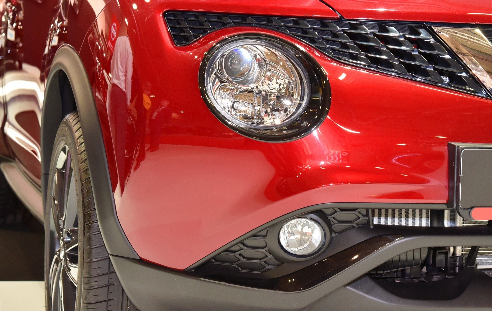 Close-up of front headlight and fog light with grille detail