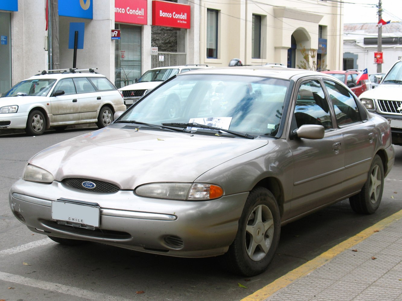 Rounded front grille, integrated headlights, alloy wheels, four-door sedan.