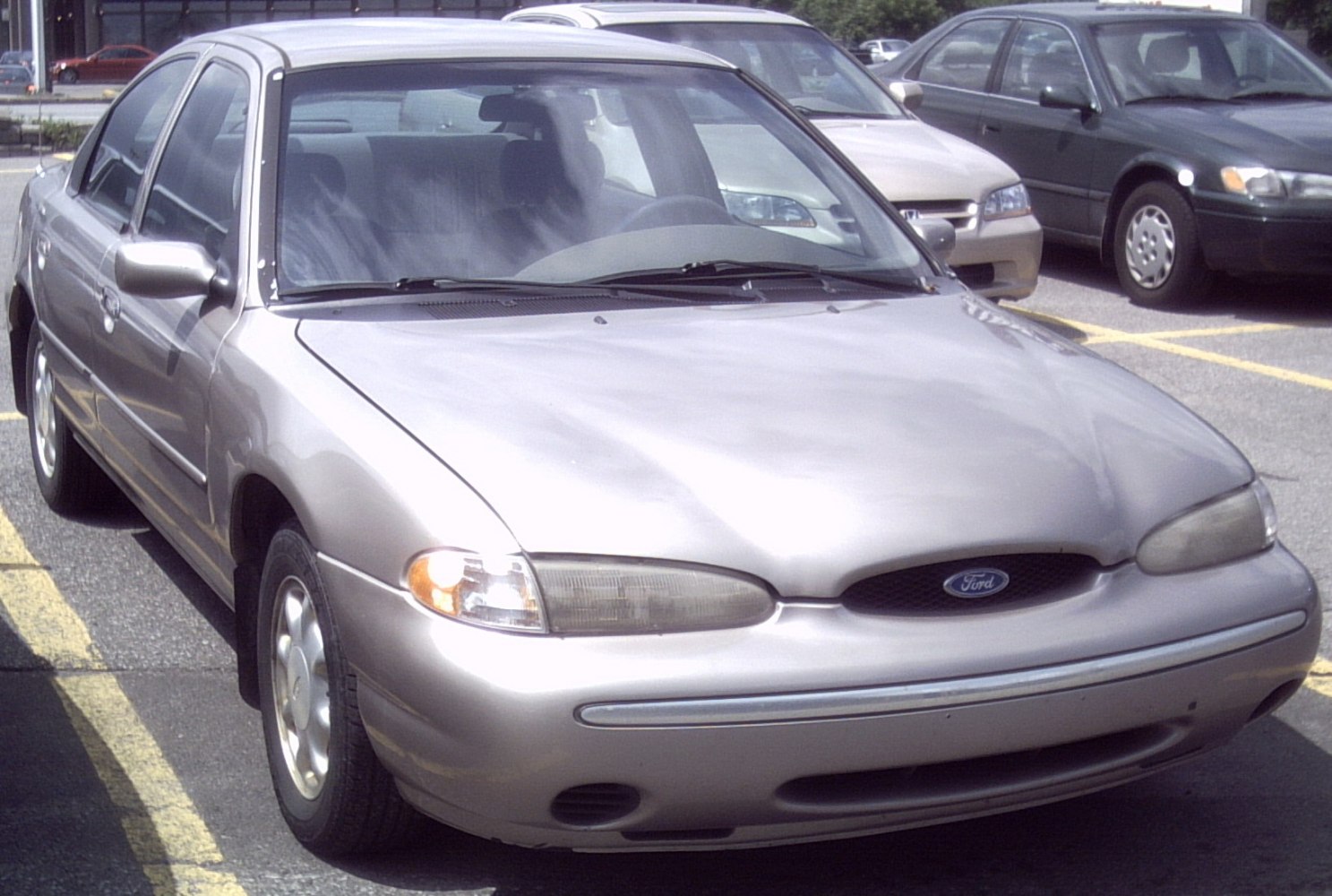 Front view of a mid-90s sedan with oval headlights and smooth bonnet lines