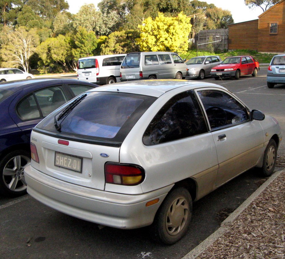 Compact hatchback rear with rounded tail lights and trapezoidal rear window