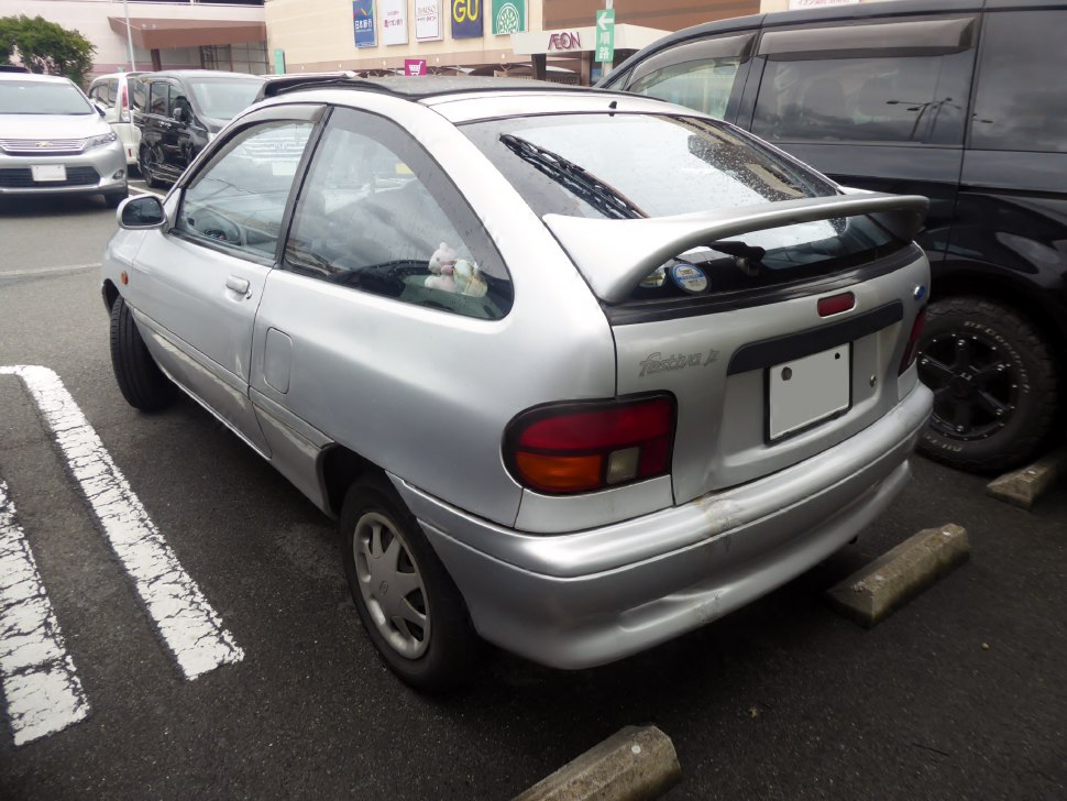 Compact hatchback rear view with spoiler and taillights