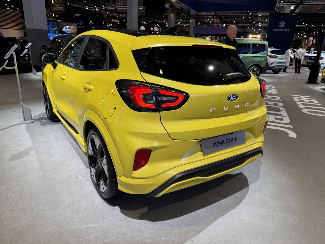 Rear view of yellow compact SUV with LED taillights and modern rear bumper