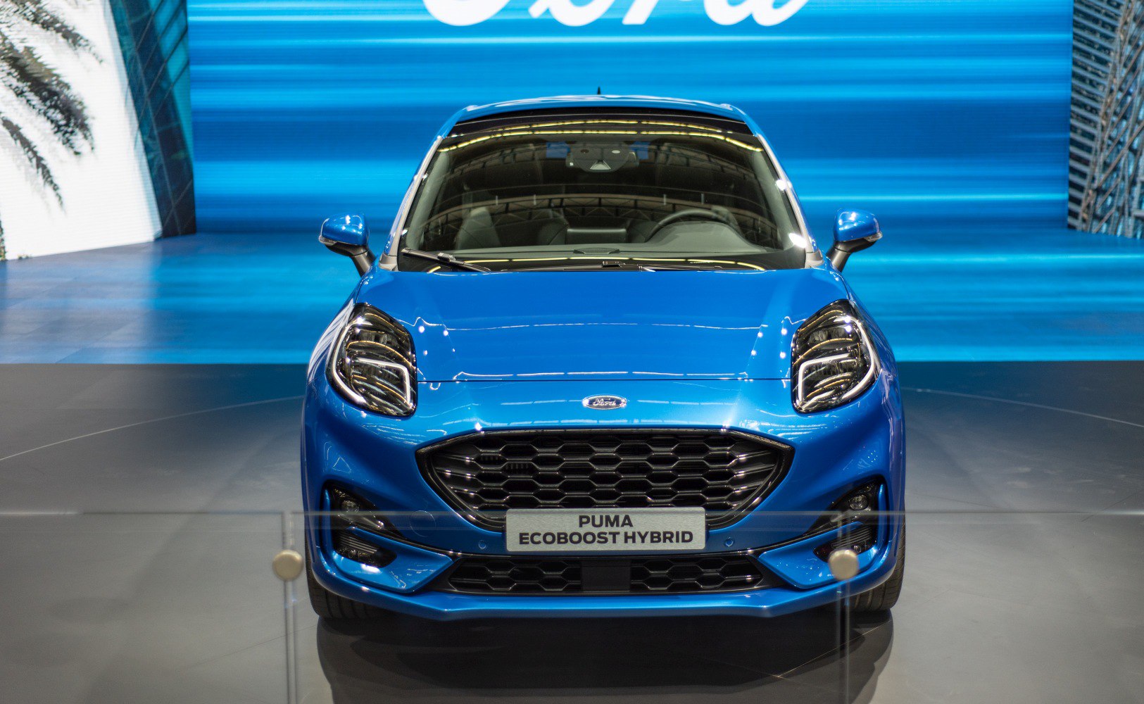 Blue vehicle front with hexagonal grille and distinct headlights