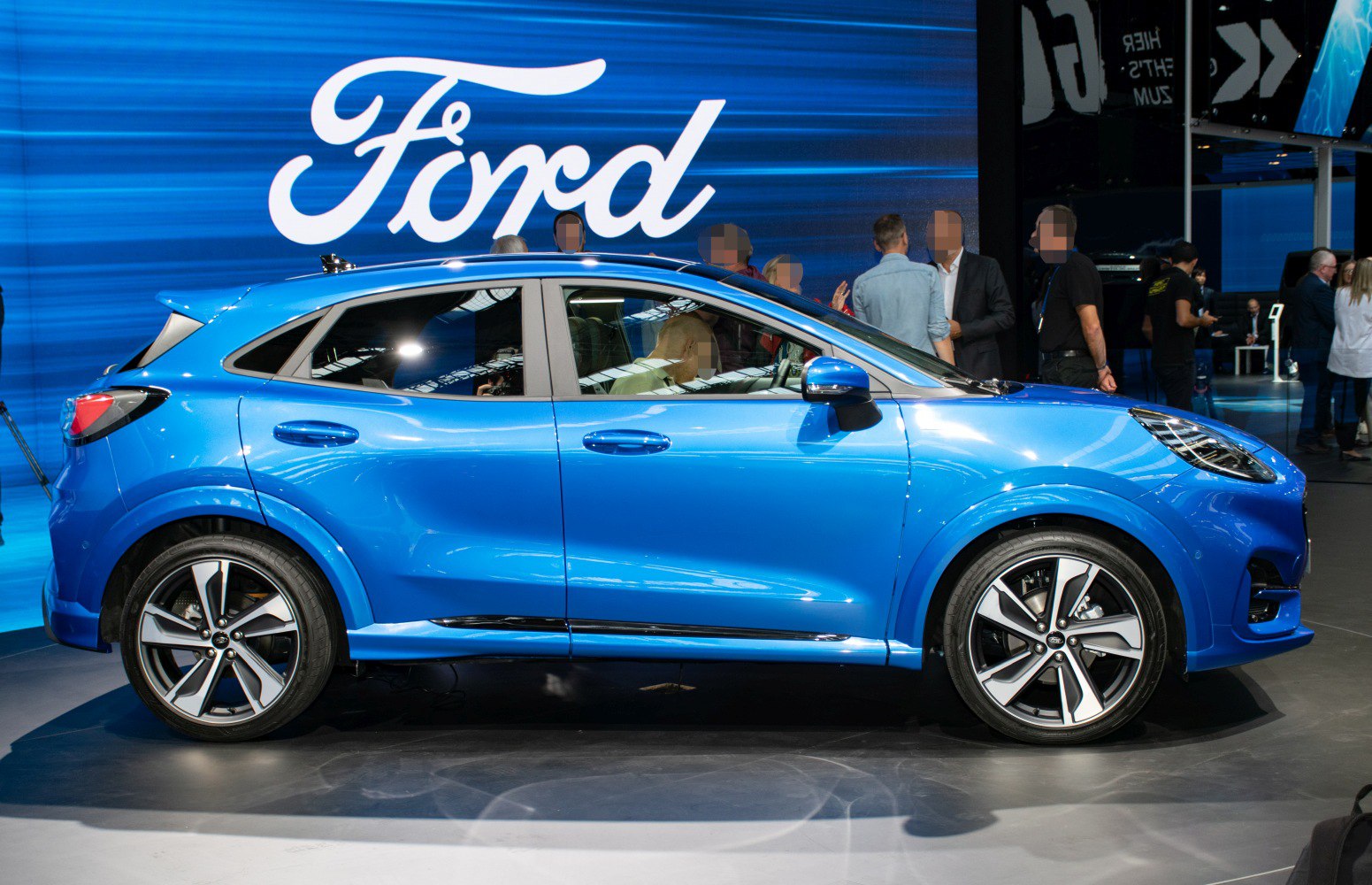 Blue compact SUV with sporty alloy wheels and sharp headlights