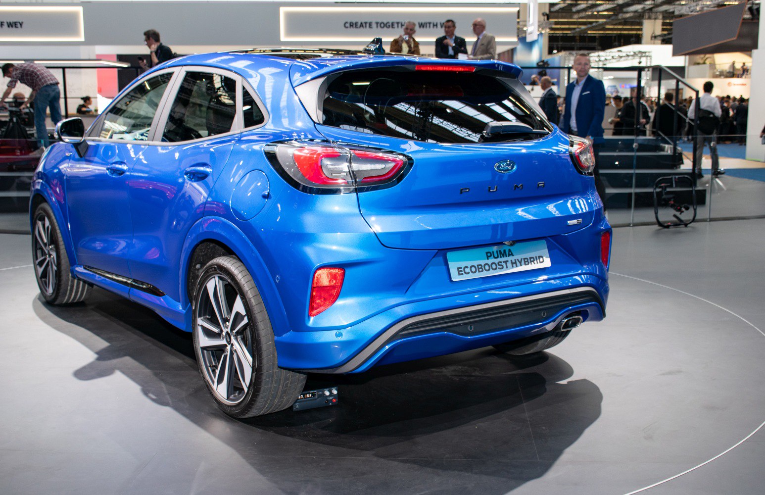 Rear view of blue compact crossover with modern tail lights and sporty bumper
