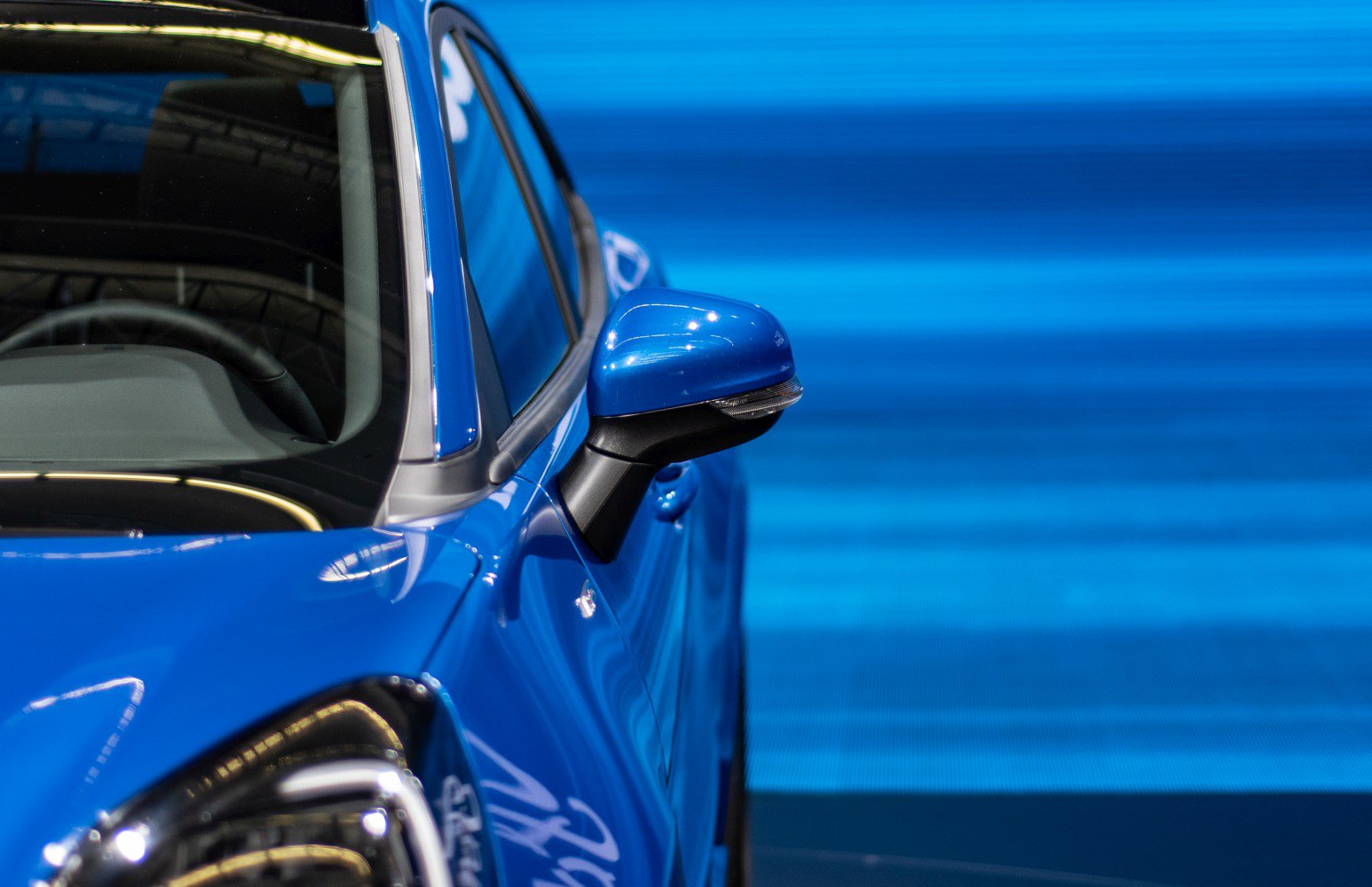 Close-up of side mirror and front windshield with window trim