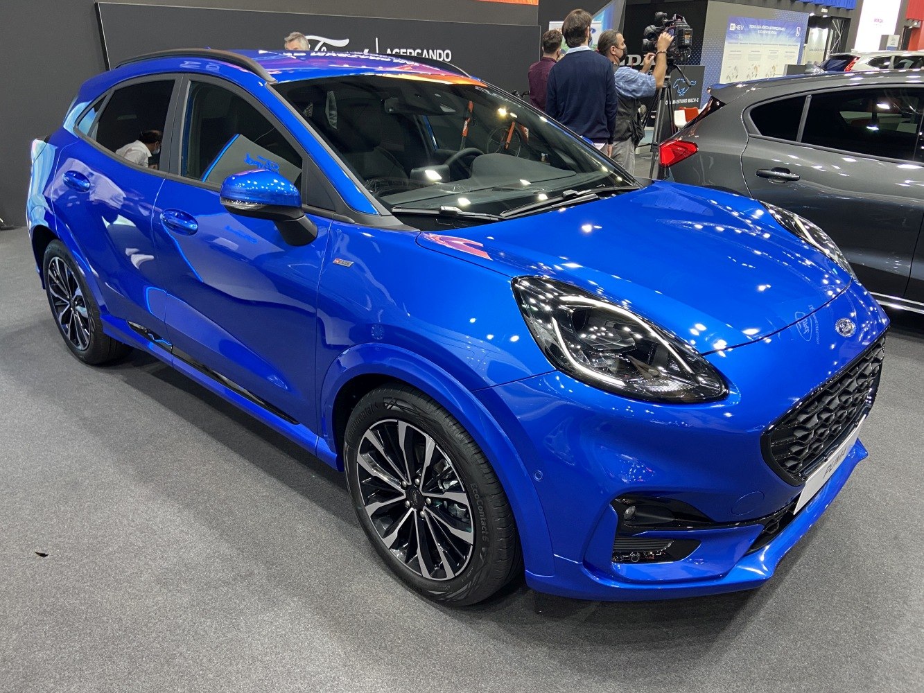 Blue compact SUV front side with alloy wheels and sleek headlights