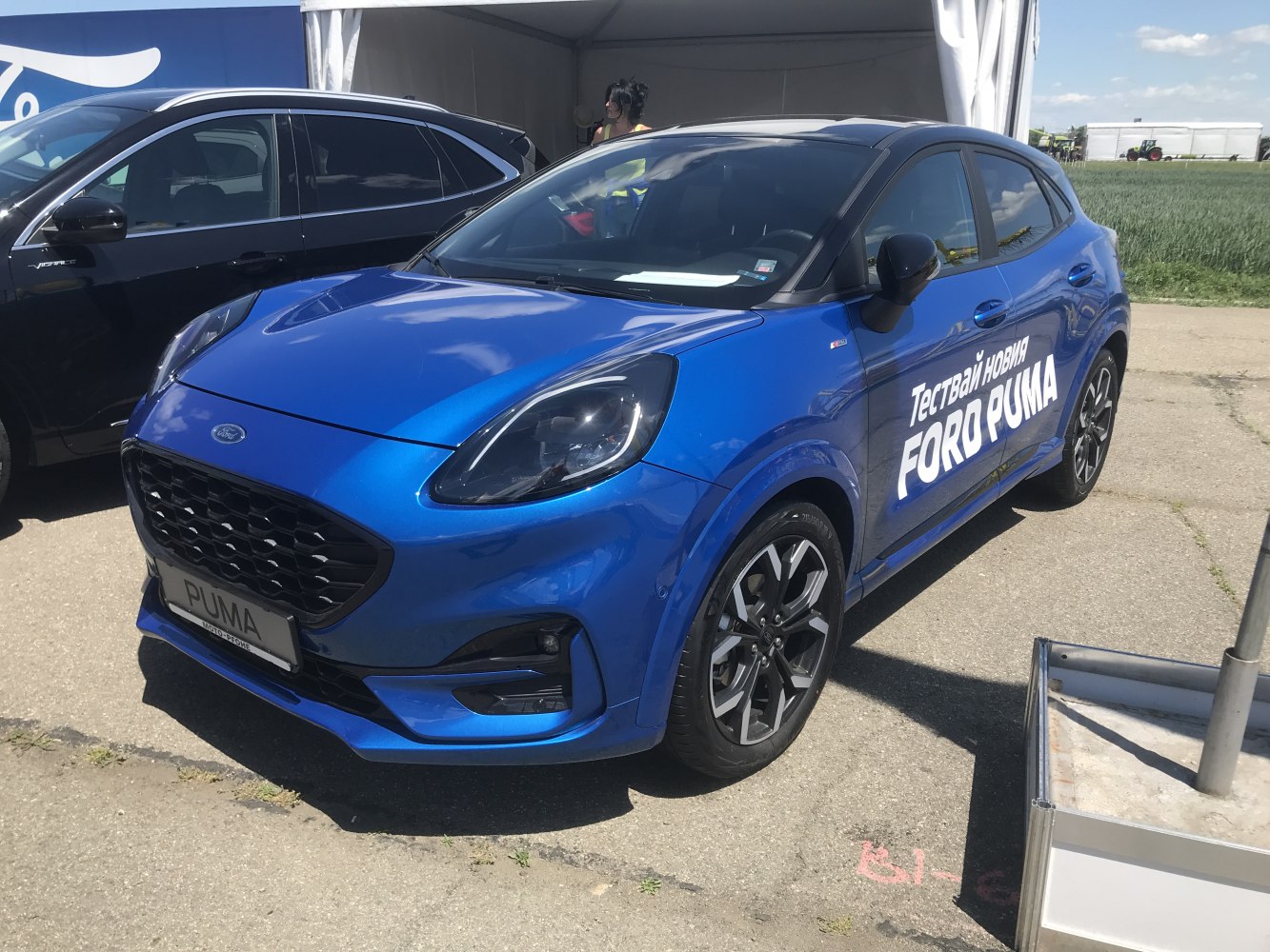 Blue compact SUV with LED headlights and sporty wheels, black roof contrast.