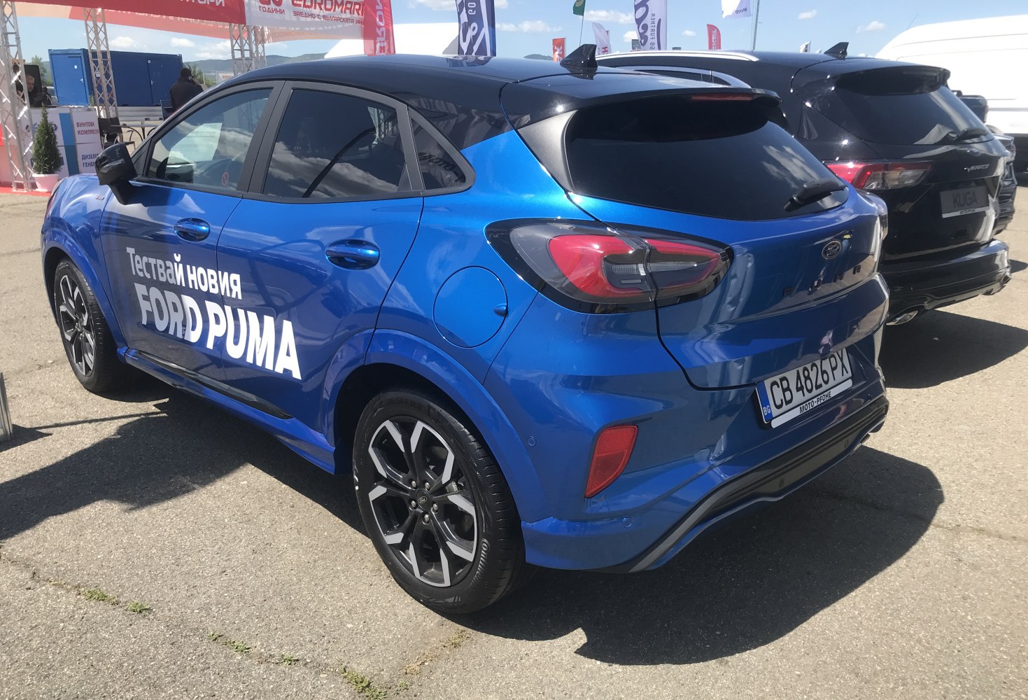 Blue compact SUV rear side with black roof and sporty wheels