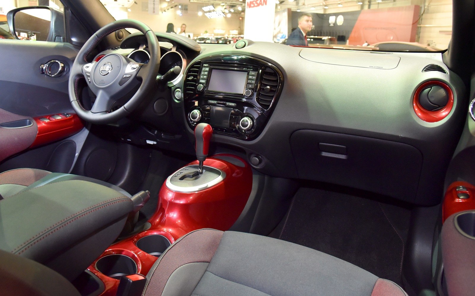 Dashboard, center console with red accents, steering wheel and controls