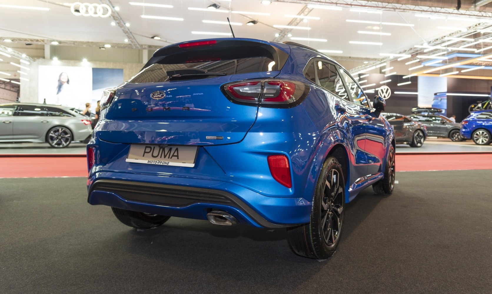 Blue compact SUV rear with modern tail lights and single exhaust