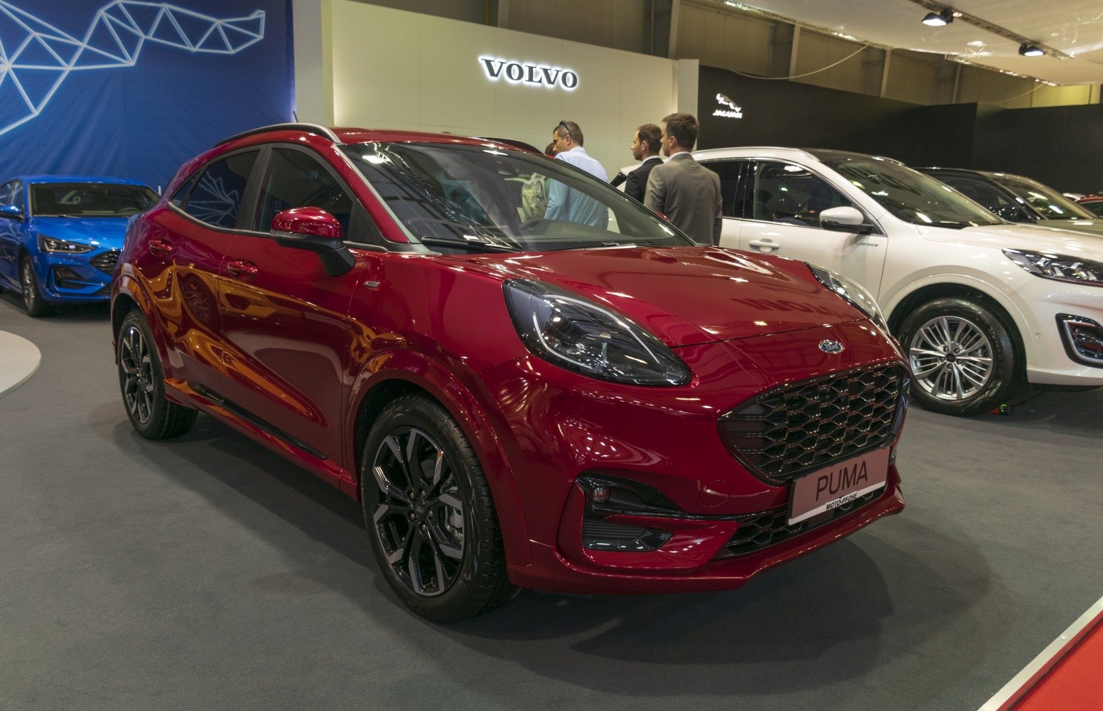 Front view with large black grille and sleek headlights