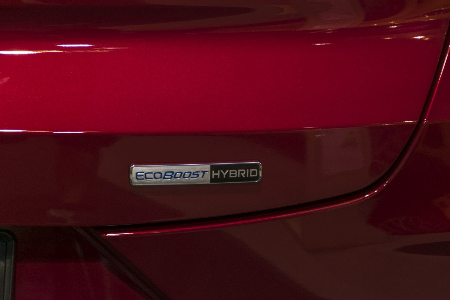 Close-up of EcoBoost Hybrid badge on red car body