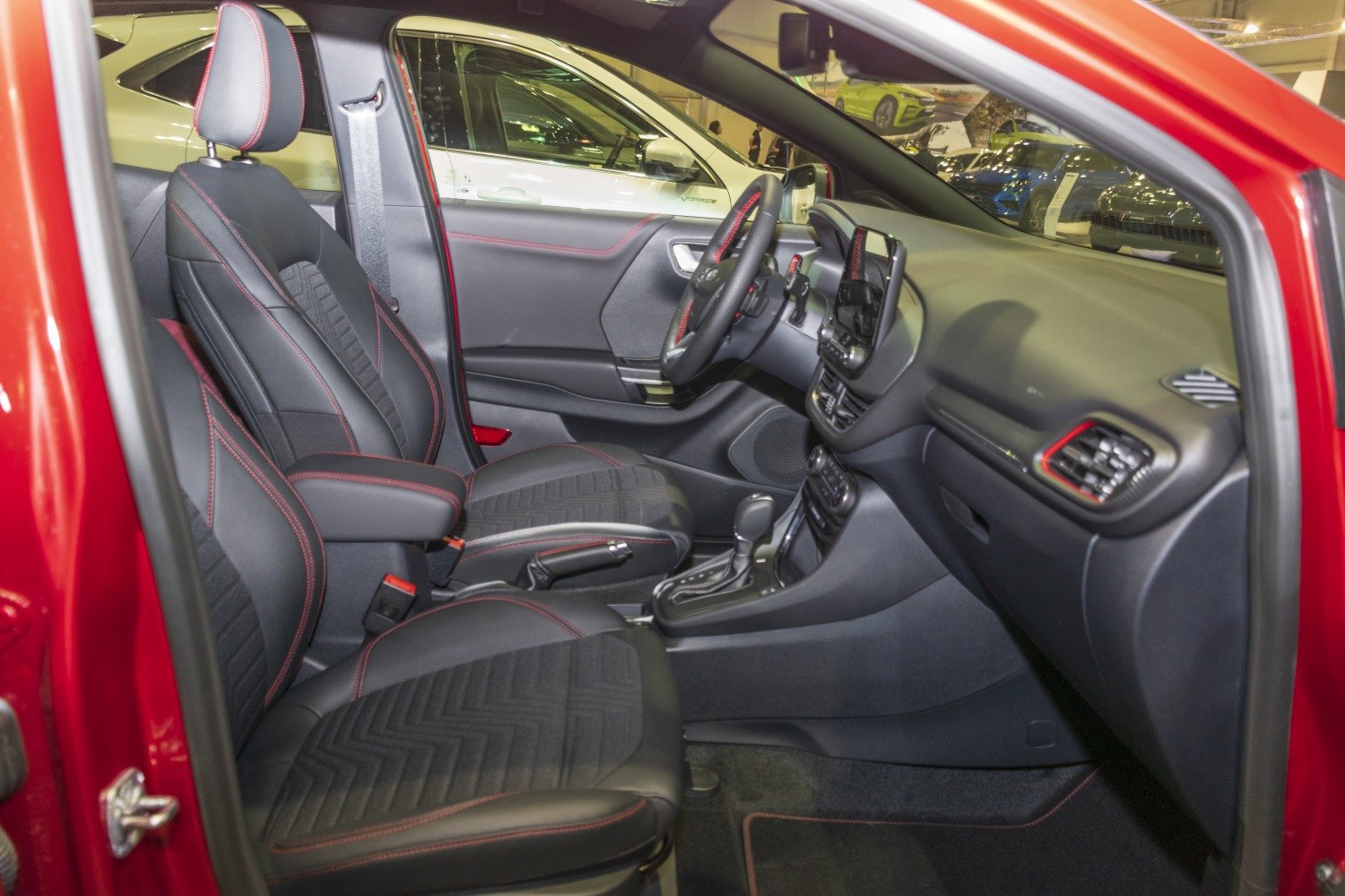 Sporty black seats with red stitching and modern dashboard design