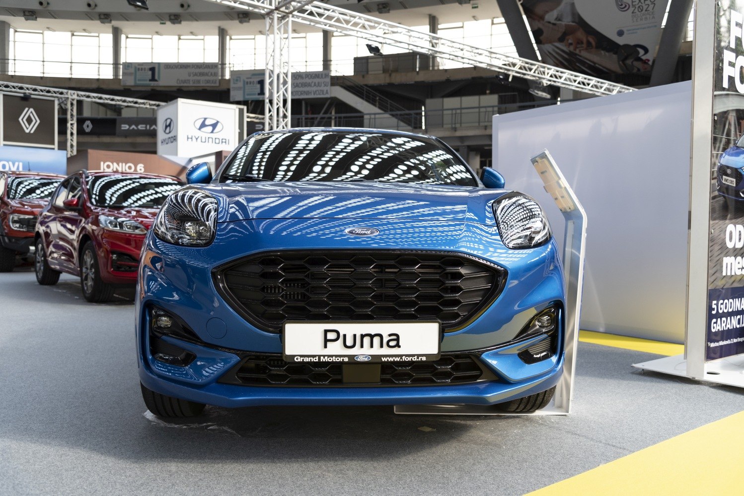 Close-up front of modern compact SUV with honeycomb grille and unique headlights