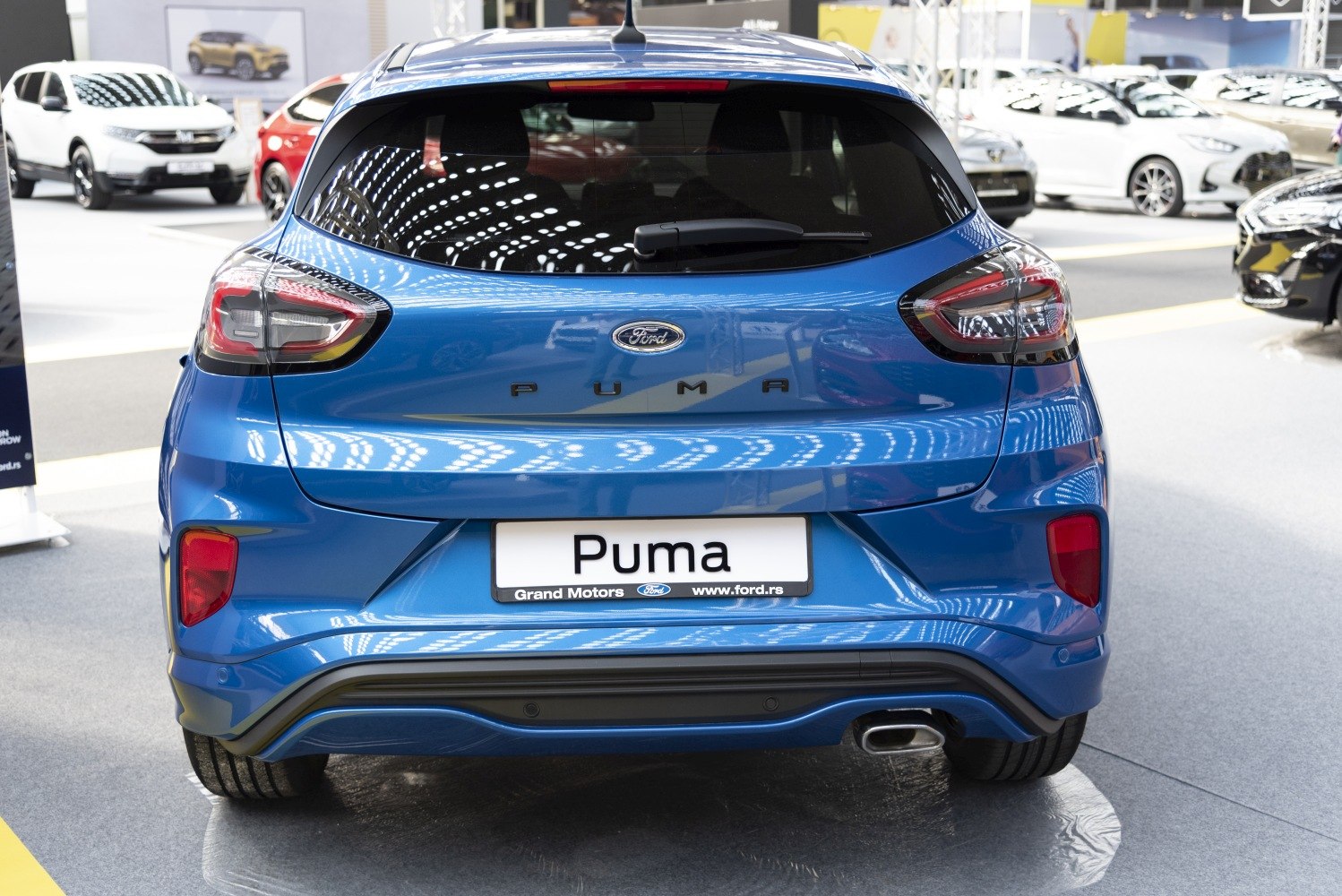 Rear view featuring tail lights, rear window wiper, and exhaust tip