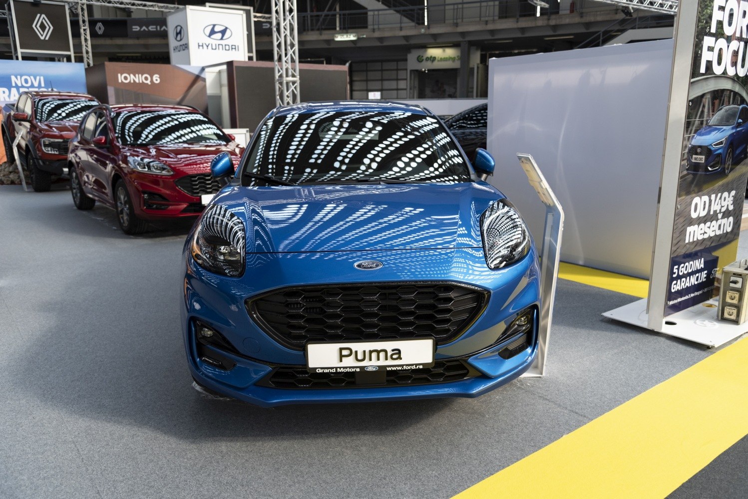 Hexagonal grille and modern headlights on a compact blue SUV front
