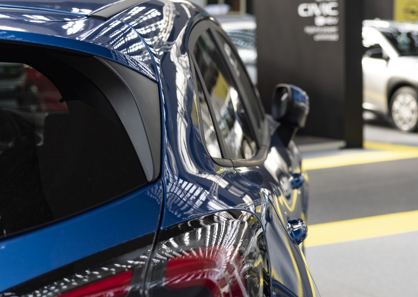 Close-up of side rear window and tail light on a blue car