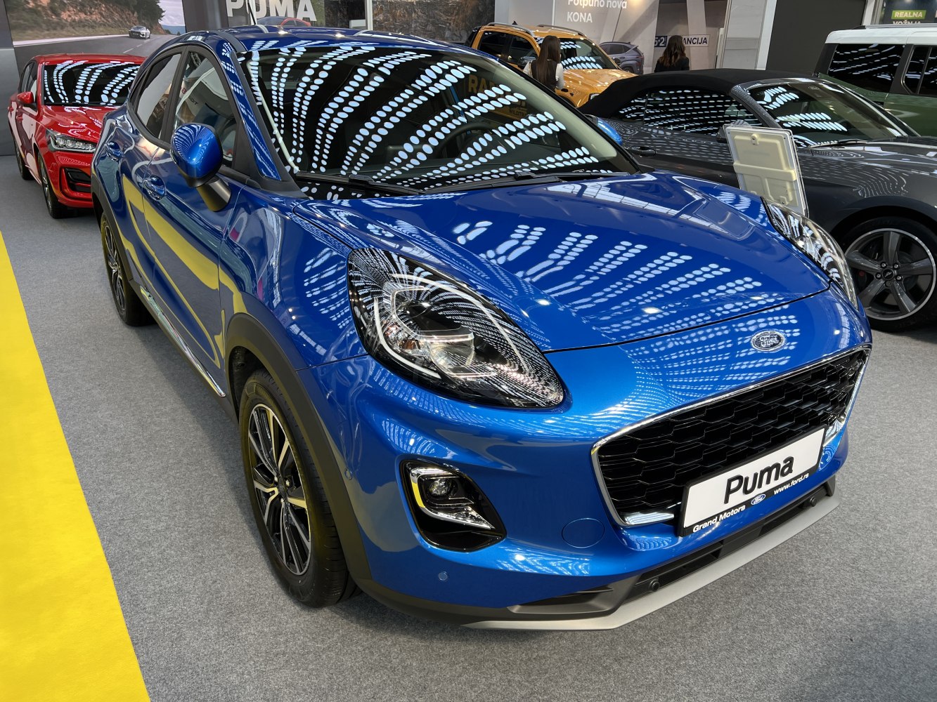 Blue compact SUV front with modern headlights and black grille