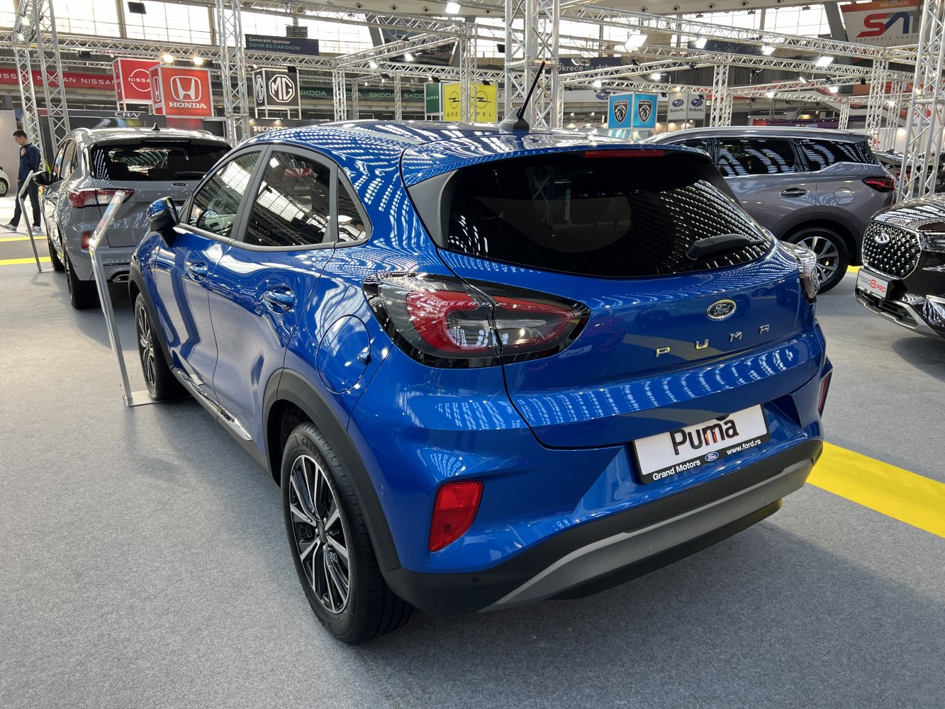 Rear view of blue compact SUV with sleek tail lights and alloy wheels