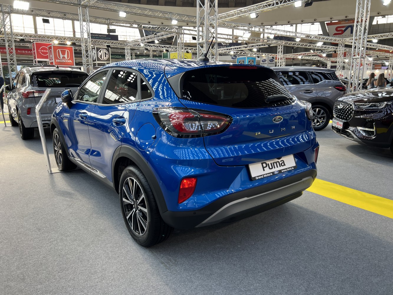 Rear side view of blue compact SUV with modern taillights and alloy wheels
