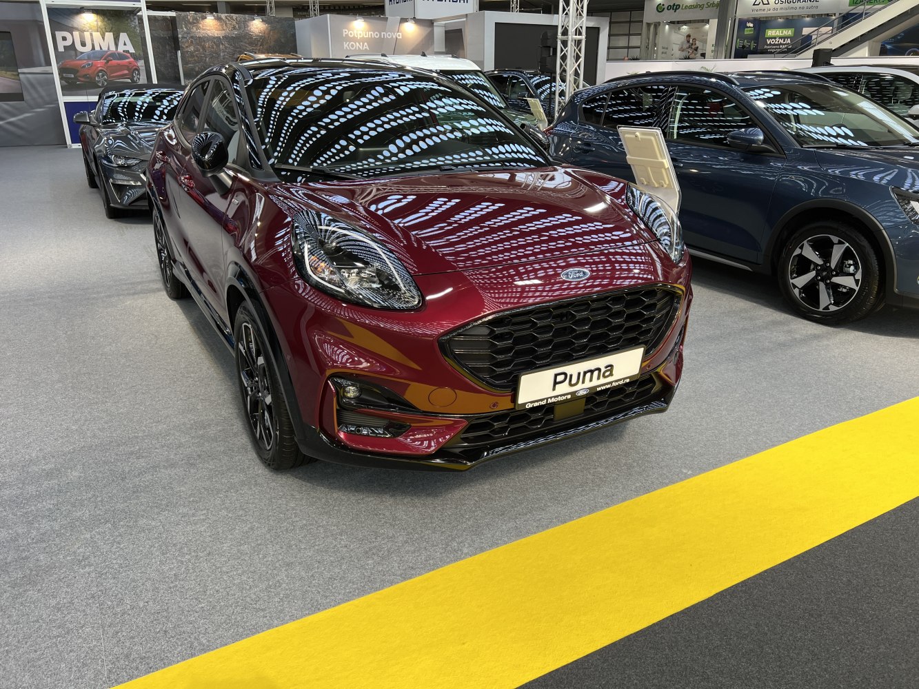 Close-up of vehicle front with honeycomb grille and LED headlights.