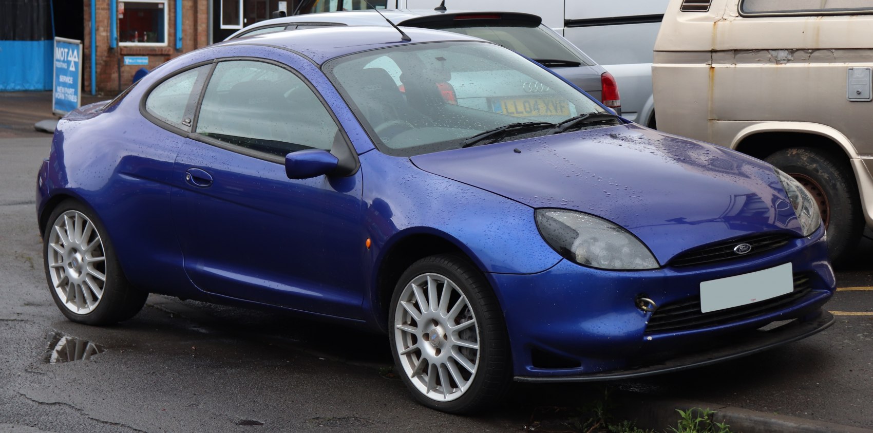 Blue coupe with aerodynamic shape and multi-spoke alloy wheels