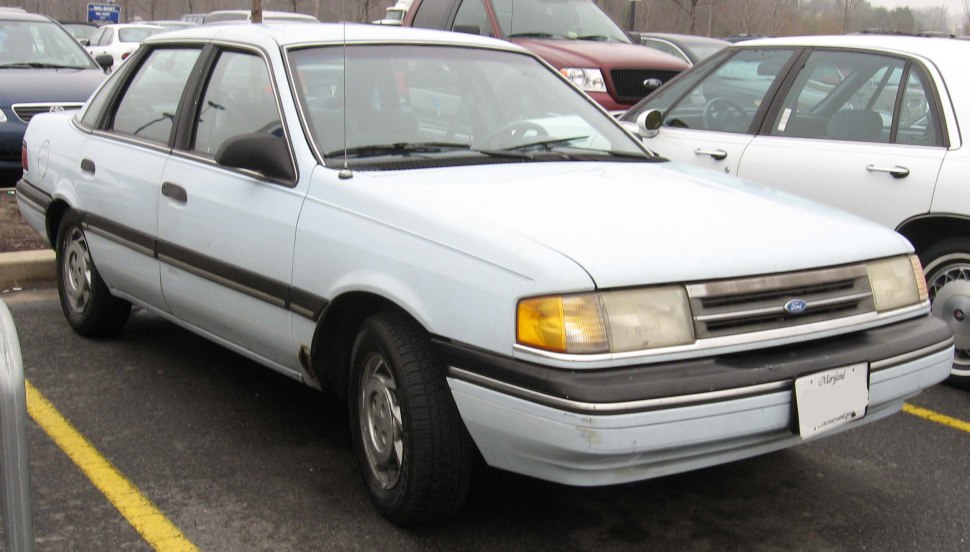 Four-door sedan with boxy design and front grille in vintage style