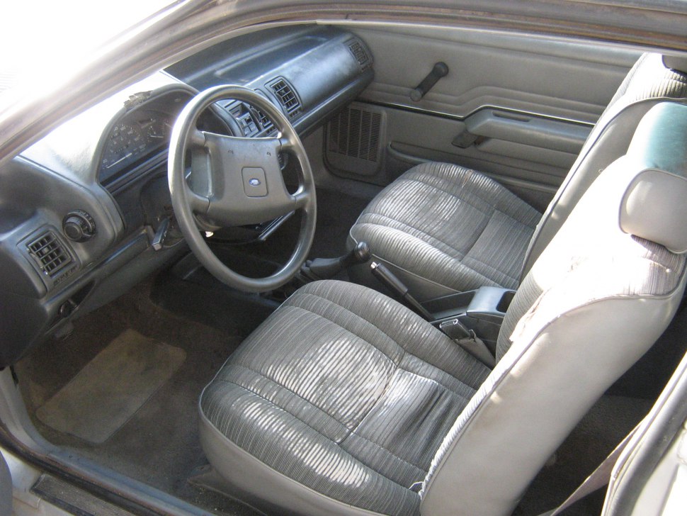 Vintage car interior with dashboard and fabric front seats