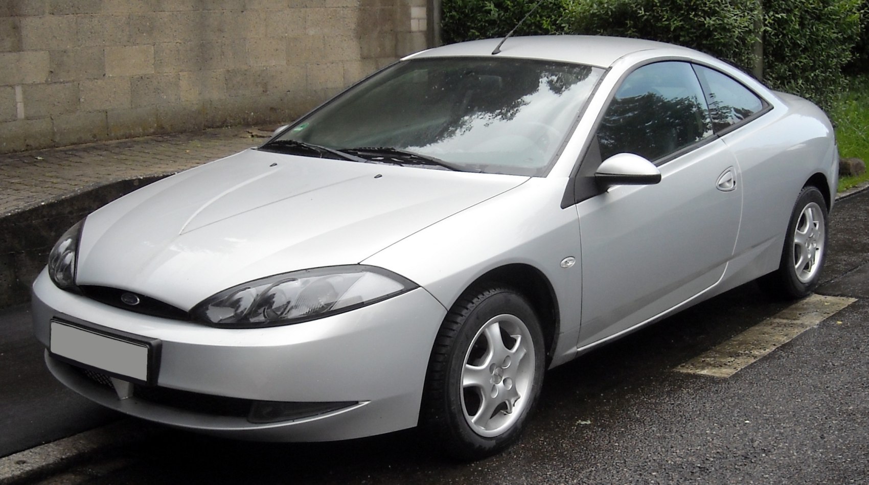 Silver sports coupe with sleek aerodynamic design and distinctive headlights