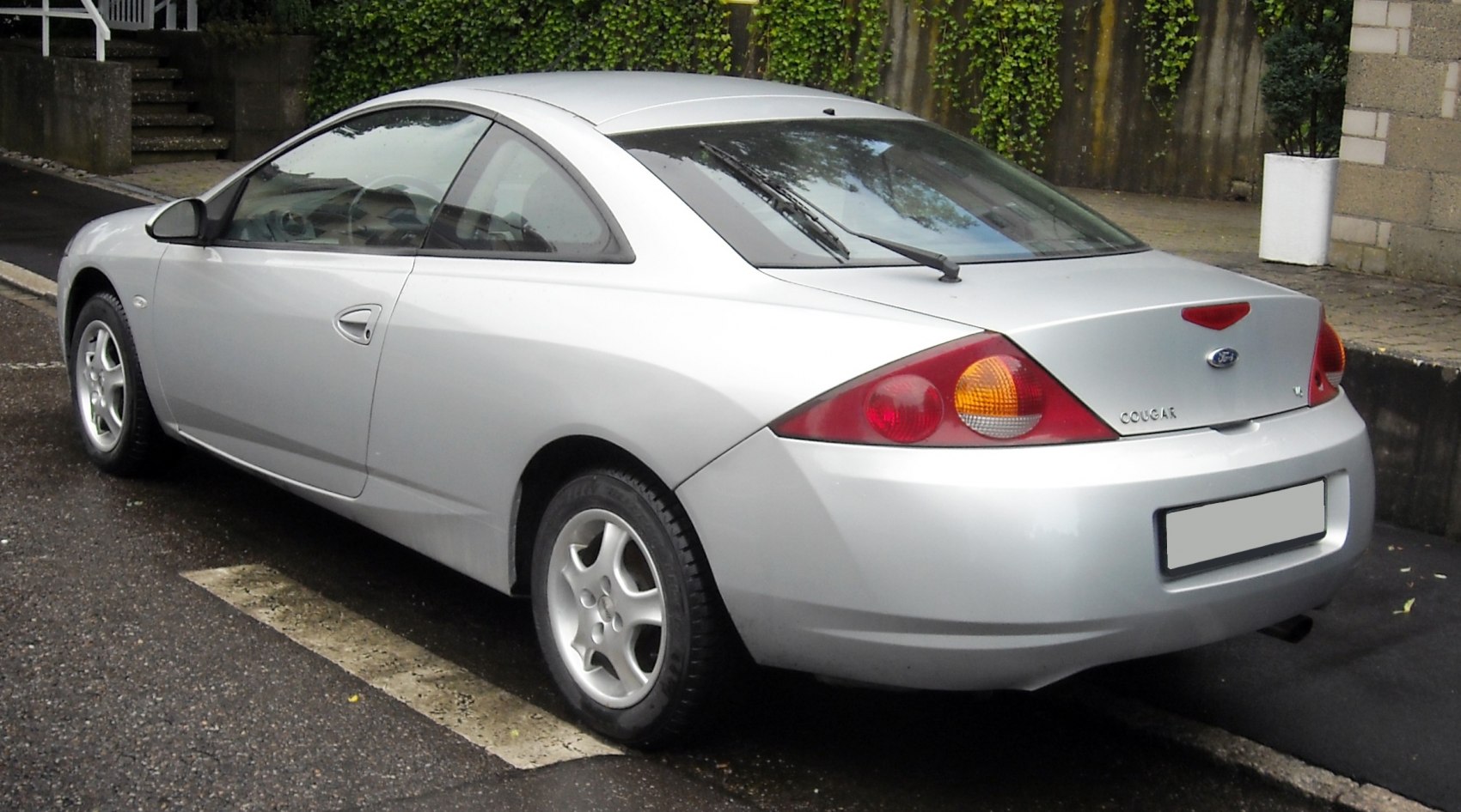Silver coupe rear-side view with rounded design and taillights.