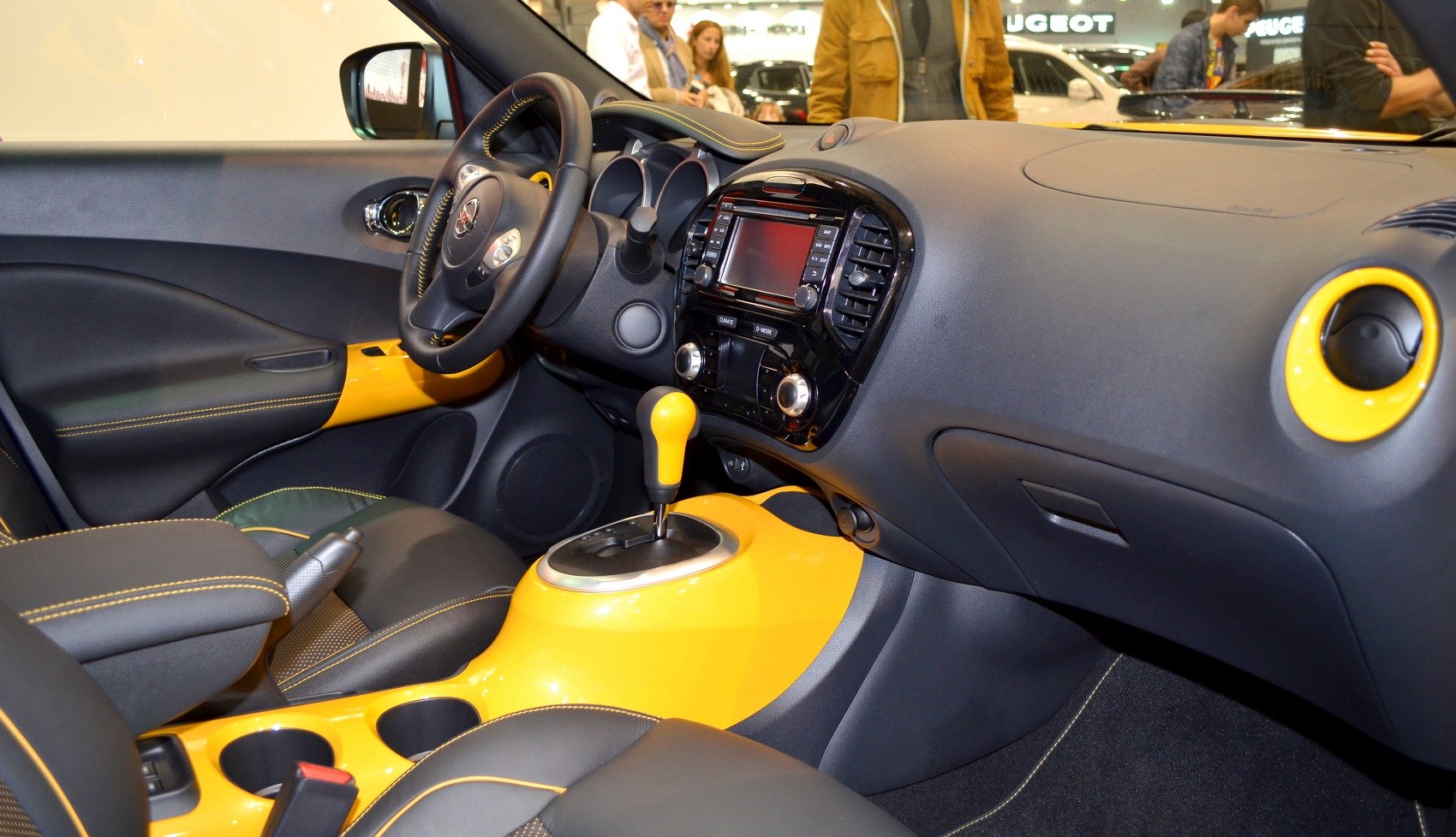 Yellow-accented modern car dashboard and automatic gear shifter
