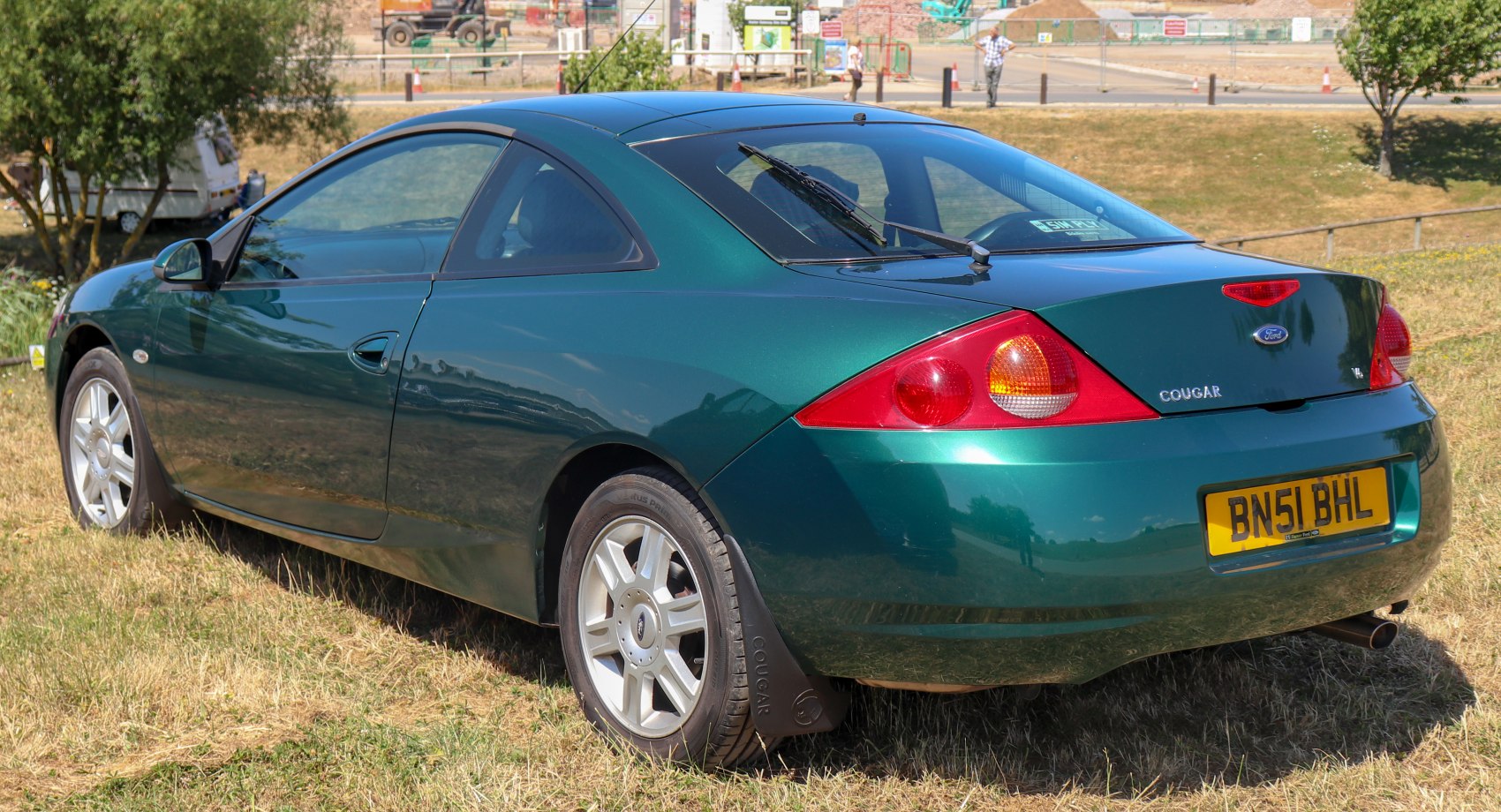 Rear and side view of a green sporty coupe with distinct taillights and rear wiper