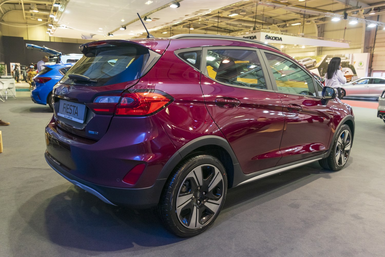Rear side view of a compact hatchback with sporty alloy wheels and raised ground clearance.