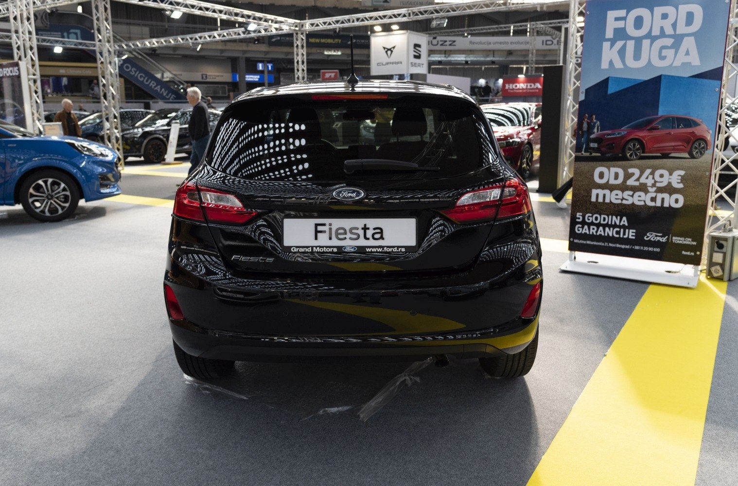 Rear view of black 5-door hatchback with distinct taillights and rear window wiper.