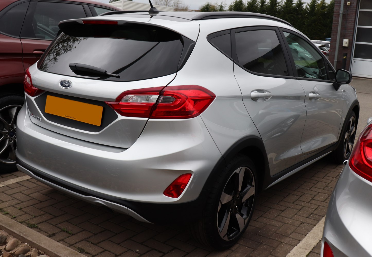 Rear and side view with tail lights and alloy wheels