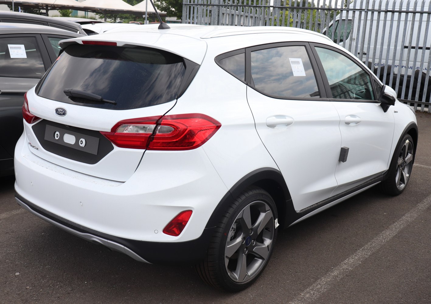 Rear and side profile of white hatchback with sporty alloy wheels and bold taillights