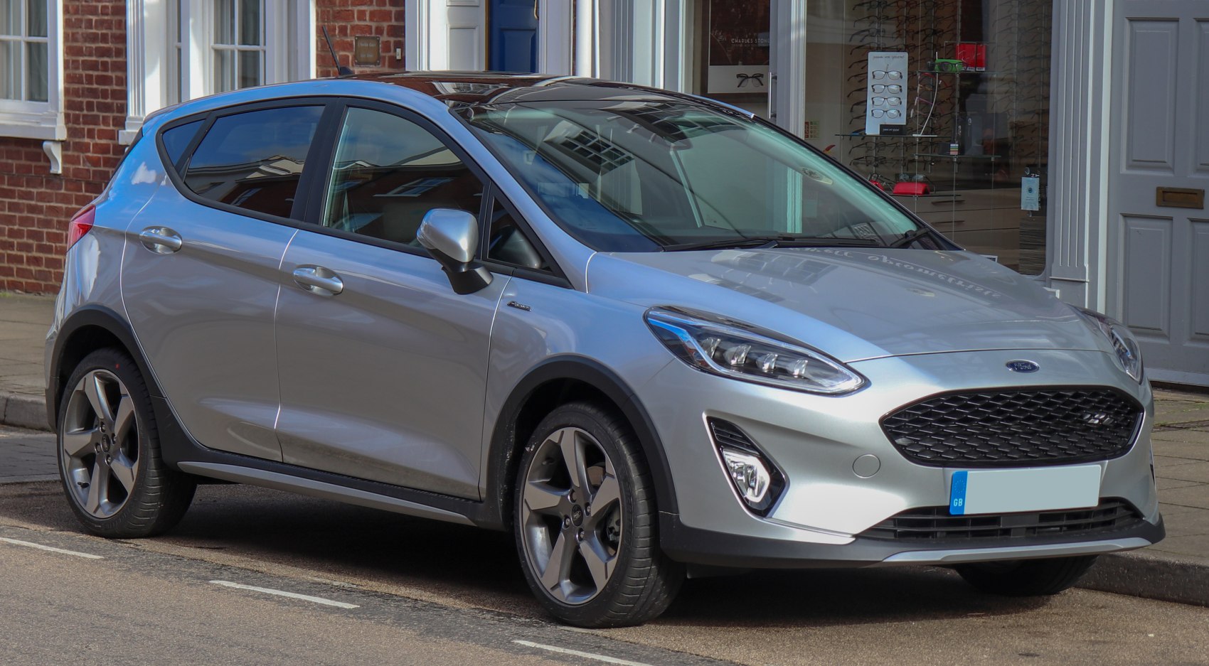 Silver compact hatchback with sporty grille and alloy wheels