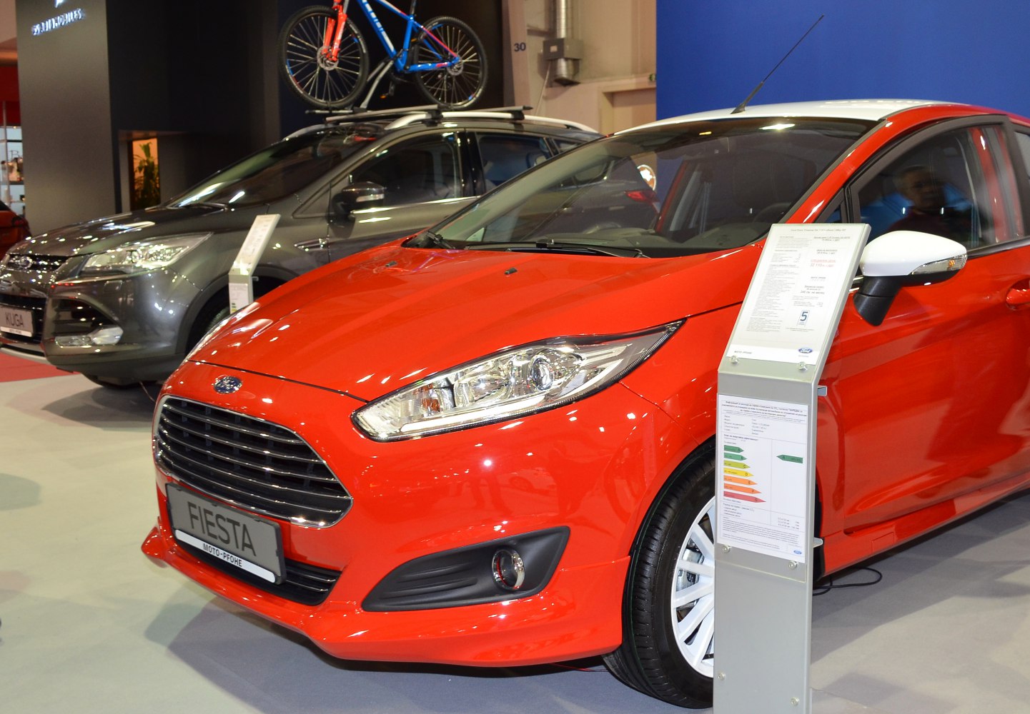 Front grille and headlight design of a modern red hatchback
