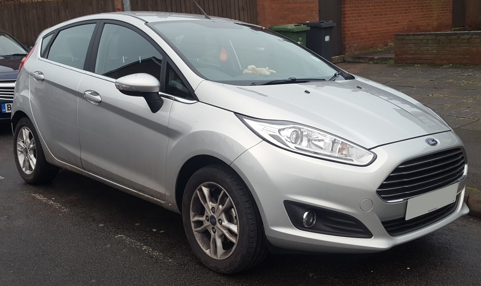 Front and side view of a silver 5-door hatchback with distinctive grille and headlights