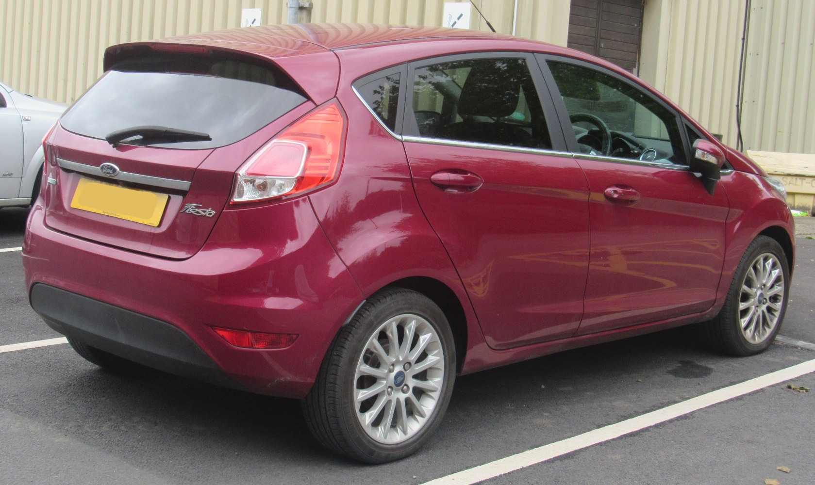 Rear view of red 5-door hatchback with alloy wheels