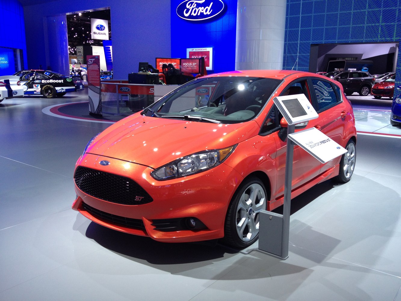 Front view of sporty hatchback with black mesh grille and alloy wheels