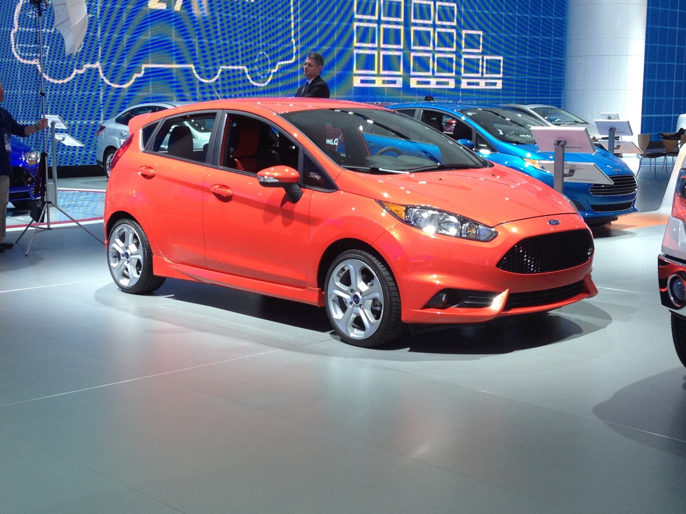 Orange 5-door hatchback with sporty grille and alloy wheels
