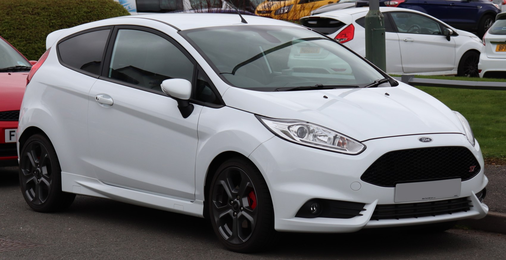 Sporty 3-door hatchback with sleek headlights and black honeycomb grille