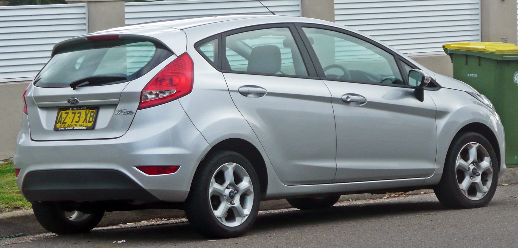 Rear side view of a silver 5-door hatchback with alloy wheels and distinctive taillights