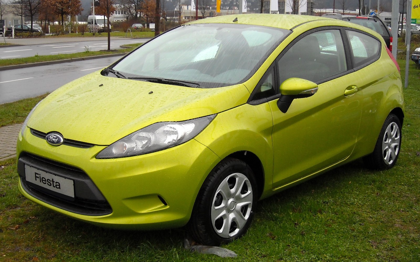 Compact 3-door hatchback with sleek headlights and silver alloy wheels